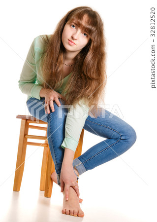 Attractive barefoot girl sitting on stool 32812520