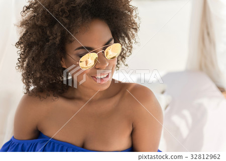 Cheery youthful mulatto woman sunbathing on Cheery youthful mulatto woman sunbathing on 32812962
