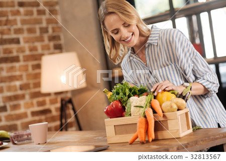Excited lively woman looking through her purchases 32813567