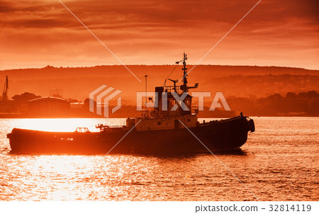 Black sea port at sunset. Tug boat is underway 32814119