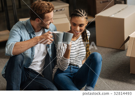 Smiling woman touching cups with her man Smiling woman touching cups with her man 32814493