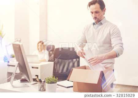 Burned out young man packing his things 32815029