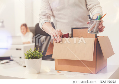 Sad dismissed worker taking his office supplies 32815058