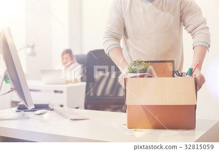 Productive fired gentleman cleaning his workplace 32815059