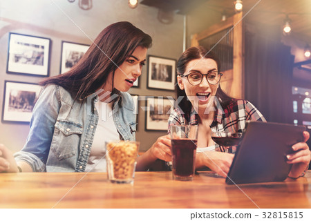 Happy female pointing at her device Happy female pointing at her device 32815815