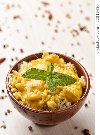 shrimp tikka masala and rice in a bowl 32816450