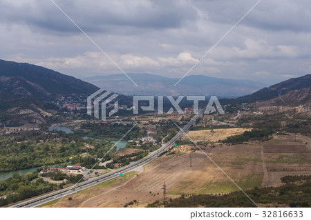Mountain town with road and lake 32816633