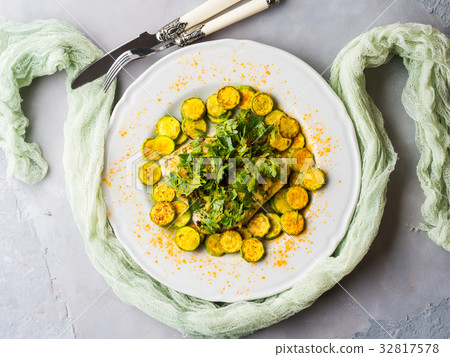 Stock fish fillet with turmeric courgettes 32817578