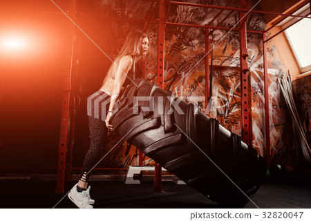 young female fitness model execute exercise with 32820047