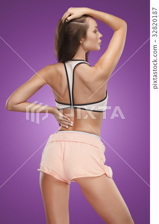 Muscular young woman athlete posing at studio Muscular young woman athlete posing at studio 32820187