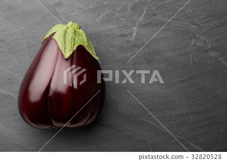 Fresh eggplant on dark stone background Fresh eggplant on dark stone background 32820528