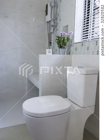 Alarm clock and flower in modern bathroom interior Alarm clock and flower in modern bathroom interior 32820582