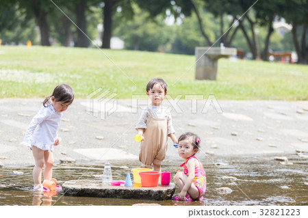 Children playing with water Children playing with water 32821223