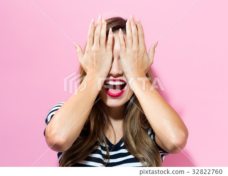 Young woman covering her eyes 32822760