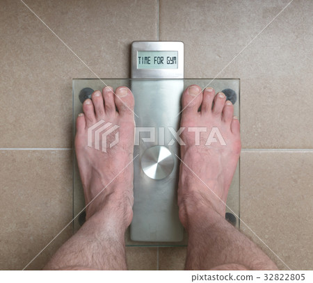 Man's feet on weight scale - Time for gym Man's feet on weight scale - Time for gym 32822805