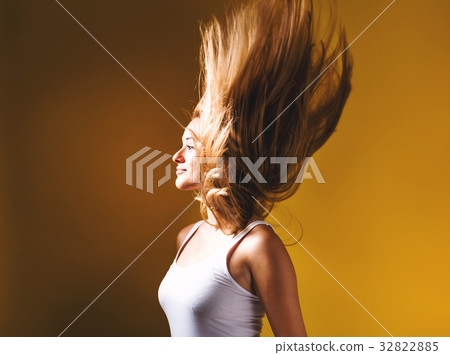 Young woman tossing her hair up 32822885