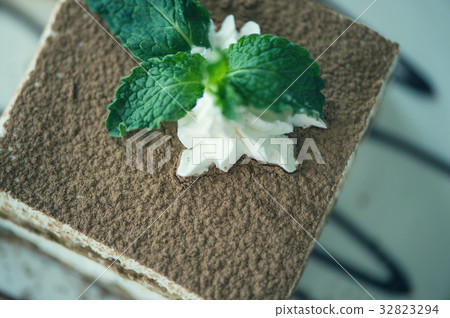 italian dessert tiramisu with mint on a plate with 32823294