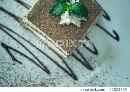 italian dessert tiramisu with mint on a plate with 32823295