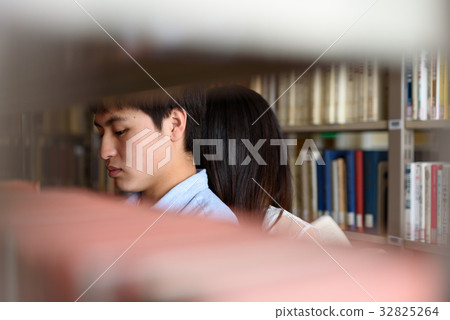 University student doing research in library 32825264
