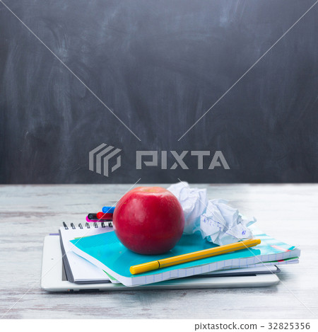 Apple with school supplies 32825356