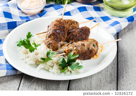 Barbecued kofta with rice on a plate 32826172