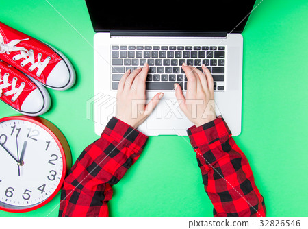 hands and huge clock with gumshoes near laptop hands and huge clock with gumshoes near laptop 32826546
