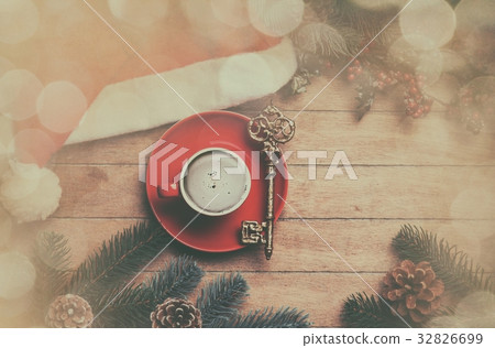 Cappuccino with key on wooden table. Cappuccino with key on wooden table. 32826699