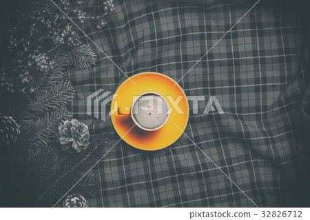 Cappuccino and  pine branch on tartan background 32826712