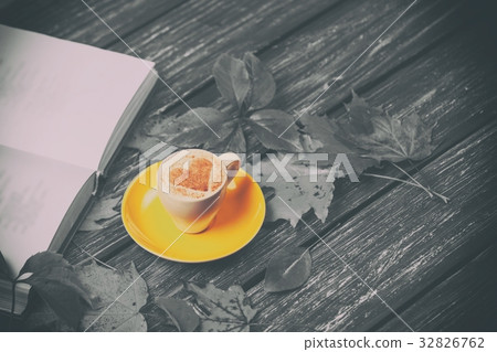 Autumn leaves, book and coffee cup  32826762
