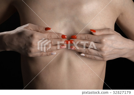 hands cover breast 32827179