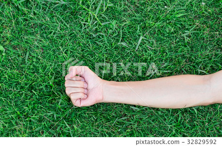 Man arm with blood veins on green grass background Man arm with blood veins on green grass background 32829592