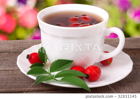 Tea from the hips on the wooden table with a Tea from the hips on the wooden table with a 32831145