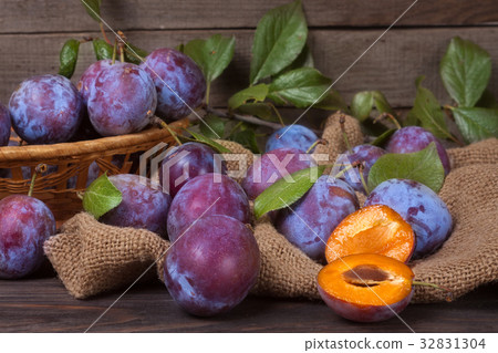plum in a wicker basket on the wooden background plum in a wicker basket on the wooden background 32831304