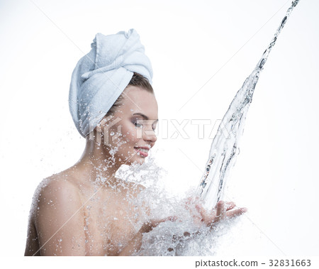 Happy girl and water stream falling to her hands Happy girl and water stream falling to her hands 32831663