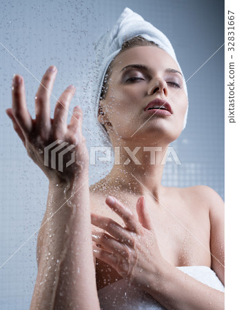 Young girl enjoying water splashes on her face Young girl enjoying water splashes on her face 32831667