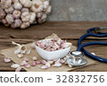 seed garlic and stethoscope on old wooden table 32832756
