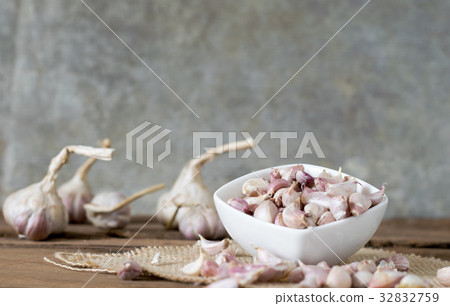 garlic on old wooden table with old wallpaper garlic on old wooden table with old wallpaper 32832759