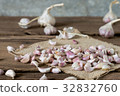 garlic on old wooden table with old wallpaper 32832760