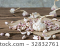 garlic on old wooden table with old wallpaper 32832761