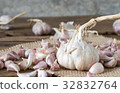 garlic on old wooden table with old wallpaper 32832764