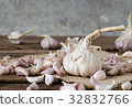 garlic on old wooden table with old wallpaper 32832766
