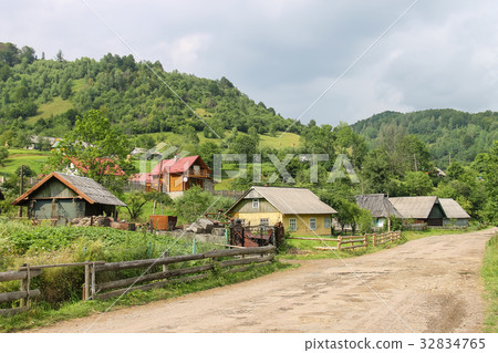 Rural houses on slope of forested mountains 32834765