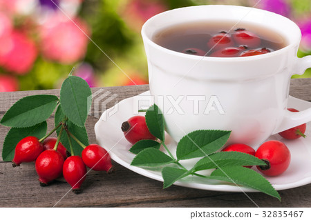 Tea from the hips on the wooden table with a Tea from the hips on the wooden table with a 32835467