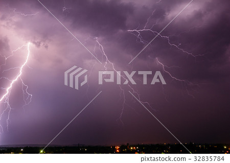 Thunderstorm with lightning in the sky over a town Thunderstorm with lightning in the sky over a town 32835784