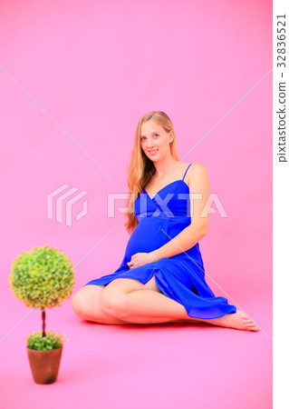 Blonde pregnant woman in blue dress @ studio photography 32836521
