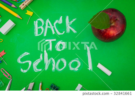 School supplies on Green chalkboard " Back to school background " . 32841661
