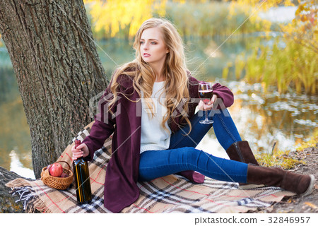 Beautiful woman drinking wine outdoors having Beautiful woman drinking wine outdoors having 32846957