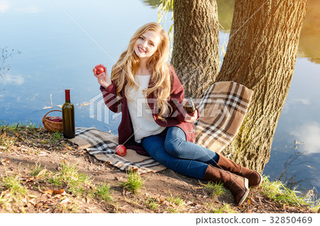 Beautiful woman drinking wine outdoors having Beautiful woman drinking wine outdoors having 32850469