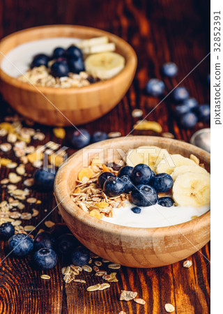 Bowls of Granola, Banana, Blueberry and Yoghurt. Bowls of Granola, Banana, Blueberry and Yoghurt. 32852391