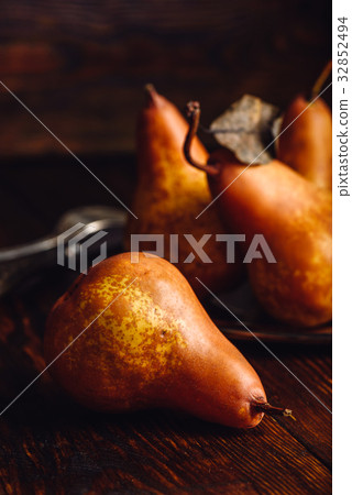 Few Golden Pears on Table. 32852494
